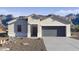 Charming single-story home featuring a two-car garage, neutral color palette, and a low-maintenance desert landscape at 2255 W Sheridan Ave, Apache Junction, AZ 85120