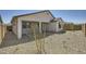 Low-maintenance backyard features desert landscaping, with rock and small native trees, plus a covered patio at 25188 N 174Th Ave, Surprise, AZ 85387