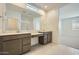 Bathroom featuring double sinks, a shower, and tile flooring at 25188 N 174Th Ave, Surprise, AZ 85387
