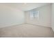 Bedroom with carpet flooring, a window, and ample natural light at 25188 N 174Th Ave, Surprise, AZ 85387