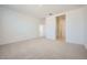 Spacious bedroom with carpet flooring and a view into the bathroom at 25188 N 174Th Ave, Surprise, AZ 85387