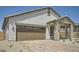 Charming single-Gathering home featuring stucco siding, brick accents, and a large two car garage at 25188 N 174Th Ave, Surprise, AZ 85387