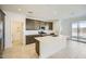 Modern kitchen with a large center island, white countertops, and stainless steel appliances at 25188 N 174Th Ave, Surprise, AZ 85387