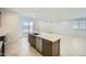 Bright kitchen features a large island with stainless steel appliances and tile flooring at 25188 N 174Th Ave, Surprise, AZ 85387