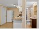 Compact kitchen with a view into the adjacent bathroom featuring a toilet and shower, optimizing space at 2636 N Dayton St, Phoenix, AZ 85006
