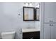 Modest bathroom with a built-in vanity, mirror, and classic toilet at 2636 N Dayton St, Phoenix, AZ 85006