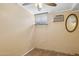 This serene bedroom features tile flooring, a window with blinds, and a classic oval mirror at 2636 N Dayton St, Phoenix, AZ 85006