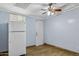Simple bedroom with a refrigerator and a door at 2636 N Dayton St, Phoenix, AZ 85006