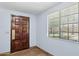 Traditional front entryway with a wood door and a window with blinds at 2636 N Dayton St, Phoenix, AZ 85006