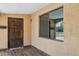 Inviting front entrance with a solid wood door, window and tile flooring, creating a welcoming arrival point at 2636 N Dayton St, Phoenix, AZ 85006