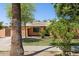 Single-story home with landscaping, a lawn, and mature trees in the front yard at 2636 N Dayton St, Phoenix, AZ 85006