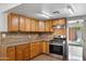Updated kitchen with wood cabinets, granite counters, stainless steel appliances, and a door to outside at 2636 N Dayton St, Phoenix, AZ 85006