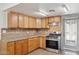 Traditional kitchen featuring wood cabinetry, granite countertops, and stainless steel appliances at 2636 N Dayton St, Phoenix, AZ 85006