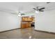 Open-concept living area with tile flooring, ceiling fans, and an adjoining kitchen at 2636 N Dayton St, Phoenix, AZ 85006