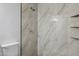 Shower with large grey tile, new shower head, and built-in shelves at 2636 N Dayton St, Phoenix, AZ 85006