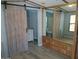 The bedroom features a barn door and built-in storage, offering space and style at 2656 N 56Th St # C160, Mesa, AZ 85215