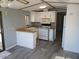 This kitchen features white appliances and cabinets with a breakfast bar, providing a cozy space for cooking at 2656 N 56Th St # C160, Mesa, AZ 85215