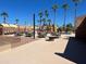 Poolside dining area with tables and umbrellas, offering a delightful spot for enjoying meals with a refreshing view at 2656 N 56Th St # C160, Mesa, AZ 85215