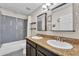 Bathroom featuring double sinks, a shower over tub, and updated fixtures at 308 E Sheffield Ct, Gilbert, AZ 85296
