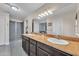 Bathroom showcasing double sinks with granite countertops and a walk-in shower at 308 E Sheffield Ct, Gilbert, AZ 85296