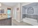 Bright bathroom showcasing a soaking tub and a granite countertop vanity with sink at 308 E Sheffield Ct, Gilbert, AZ 85296