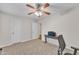 Neutral bedroom with a ceiling fan, carpeted floors, and blue desk at 308 E Sheffield Ct, Gilbert, AZ 85296