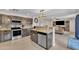 Open kitchen view with stainless steel appliances, tile backsplash, and seamless flow into the living area at 308 E Sheffield Ct, Gilbert, AZ 85296