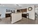 Open kitchen with granite countertops, stainless appliances, and tile backsplash, complemented by wood-look floors at 308 E Sheffield Ct, Gilbert, AZ 85296