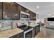 Functional kitchen showcasing stainless steel appliances, granite countertops, and modern fixtures with open concept at 308 E Sheffield Ct, Gilbert, AZ 85296