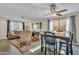 Open concept living room and dining area with dark hardwood floors and modern ceiling fan at 308 E Sheffield Ct, Gilbert, AZ 85296
