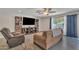 Living room featuring media center, modern furniture, hardwood-look floors, and window with light at 308 E Sheffield Ct, Gilbert, AZ 85296