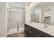 Bathroom showcasing a glass-enclosed shower with bench and double sink vanity at 3129 S 155Th Ln, Goodyear, AZ 85338