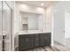 Bathroom with a double sink vanity, large mirror and modern shower at 3129 S 155Th Ln, Goodyear, AZ 85338