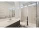 Modern bathroom featuring a glass shower, sleek vanity, and a large mirror at 3129 S 155Th Ln, Goodyear, AZ 85338