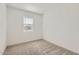Bright bedroom with neutral carpet and a window with blinds at 3129 S 155Th Ln, Goodyear, AZ 85338