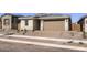 Charming single-story home featuring a two-car garage, desert landscaping, and a welcoming front entrance at 3129 S 155Th Ln, Goodyear, AZ 85338