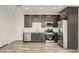 Kitchen area with stainless steel appliances and dark cabinetry at 3129 S 155Th Ln, Goodyear, AZ 85338