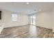 Bright open-concept living area with wood-look tile floors that connect to a kitchen with stainless appliances at 3129 S 155Th Ln, Goodyear, AZ 85338