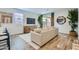 Cozy living room with a comfortable sofa, large windows, stylish decor, and hardwood flooring at 3129 S 155Th Ln, Goodyear, AZ 85338