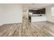 Bright open-concept living area with wood-look tile floors that connect to a kitchen with stainless appliances at 3129 S 155Th Ln, Goodyear, AZ 85338