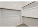 Empty walk-in closet with carpet and wooden rails at 3129 S 155Th Ln, Goodyear, AZ 85338