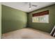 Bedroom featuring carpeted flooring, a ceiling fan, and a window with outside views at 3226 W Grovers Ave, Phoenix, AZ 85053