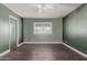 Bedroom showcasing wood-look vinyl flooring, an overhead fan, and a window with outside views at 3226 W Grovers Ave, Phoenix, AZ 85053