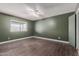 Bedroom showcasing wood-look vinyl flooring, an overhead fan, and a window with outside views at 3226 W Grovers Ave, Phoenix, AZ 85053