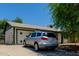 Rear view of a silver car parked in front of an attached garage at 3226 W Grovers Ave, Phoenix, AZ 85053