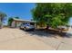 View of the front of the home with driveway, silver car, grassy area, and fenced yard at 3226 W Grovers Ave, Phoenix, AZ 85053
