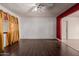 Bright living room with dark flooring, white walls, ceiling fan, and natural light at 3226 W Grovers Ave, Phoenix, AZ 85053