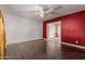 Cozy living room with wood-look floors, white walls, and access to other rooms at 3226 W Grovers Ave, Phoenix, AZ 85053