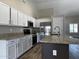Modern kitchen featuring granite counters, white cabinets, and stainless-steel appliances at 351 N Newport St, Chandler, AZ 85225