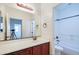 Bathroom with a large mirror, granite vanity, and bath tub and shower at 3514 S Posse Trl, Gilbert, AZ 85297
